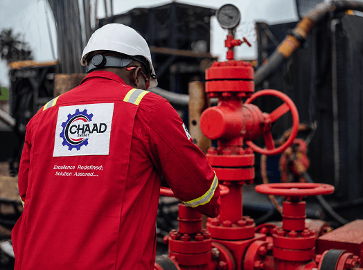 CHAAD Energy technician operating industrial valves on site